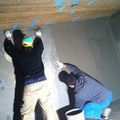 Water tank sealing with cementitious material reinforced with fiberglass mesh