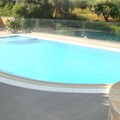 Overflow pool with blue mosaic tiling, salt electrolysis system