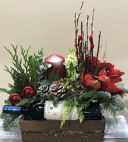 Christmas arrangement with a bottle of wine