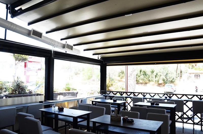 Remotely controlled awning pergola, with vertical rideau curtains and a special triangular frame