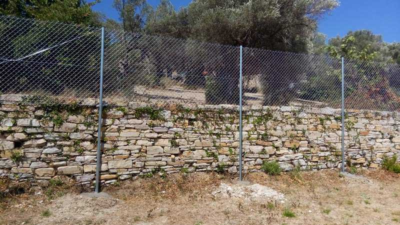 Περίφραξη πάνω σε ξερολιθιά αγροτικής περιοχής